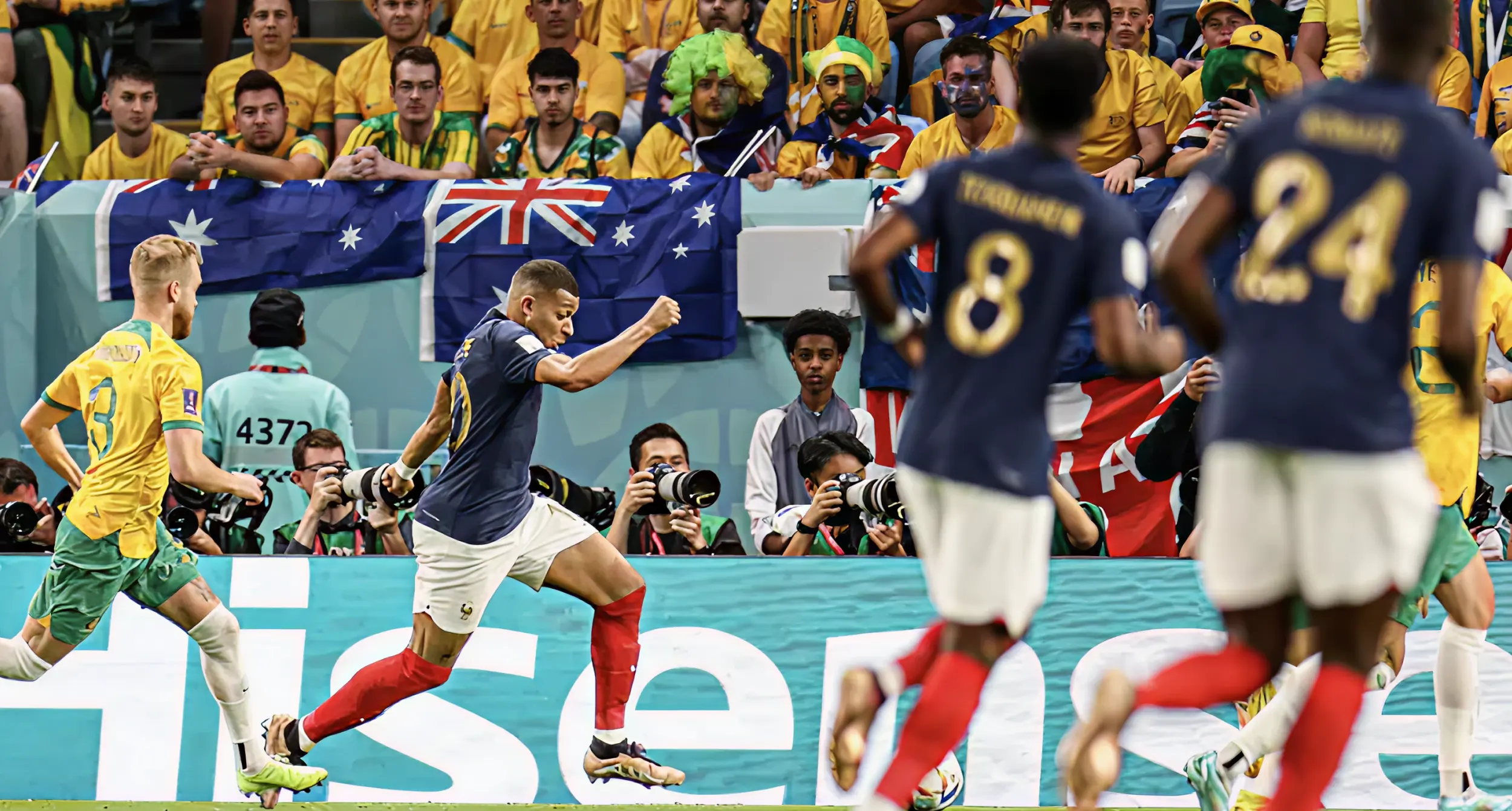 French footballer Kylian Mbappé shown on pitch at FIFA World Cup with Hisense screen in background French footballer Kylian Mbappé shown on pitch at FIFA World Cup with Hisense screen in background